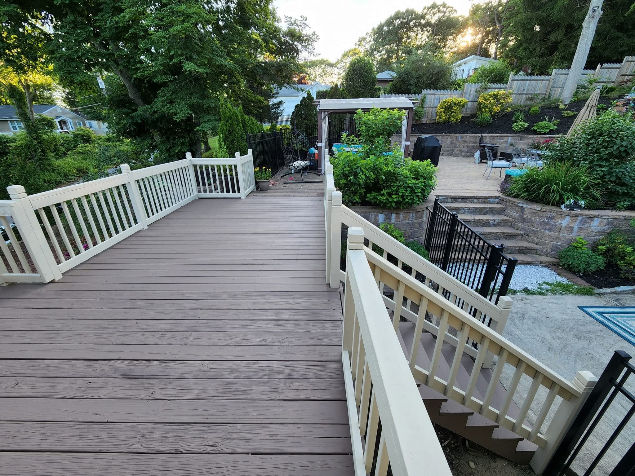 Deck railings painted cream, with brown-stained deck flooring and steps.