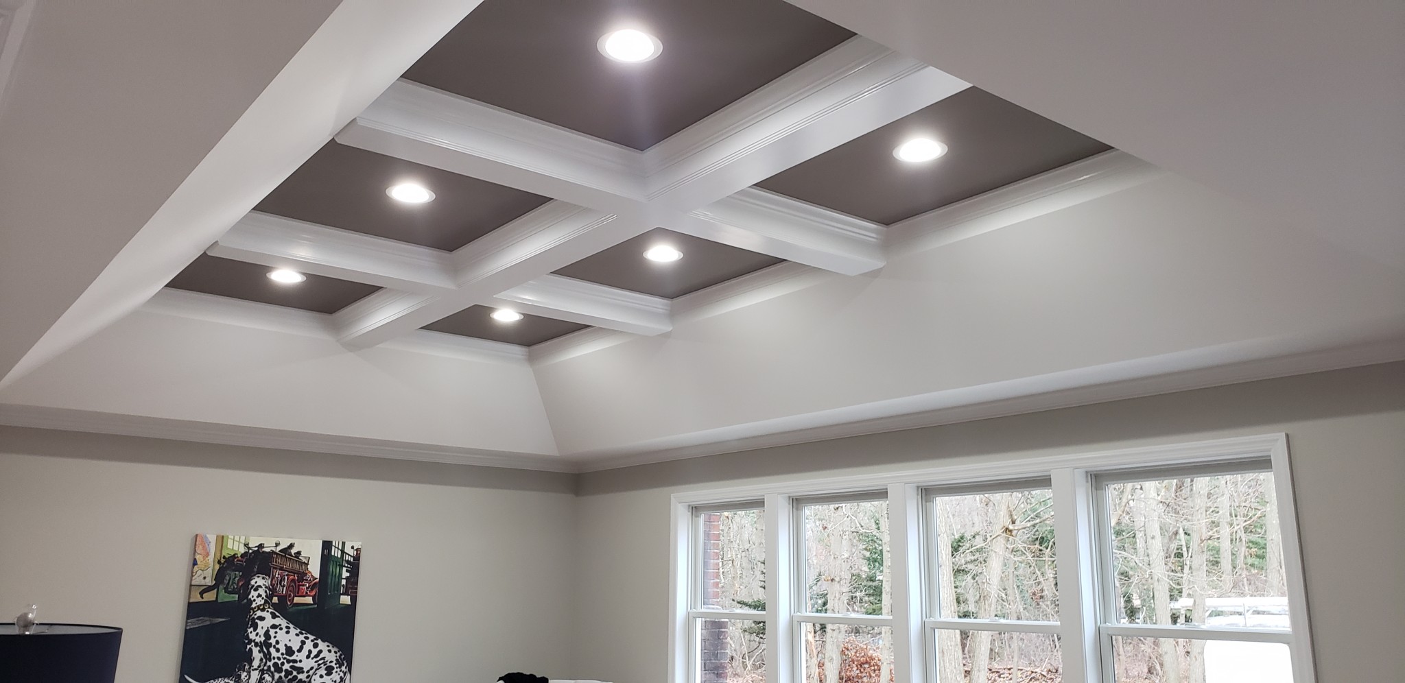 Coffered ceiling painted white and charcoal, with light gray walls and white window trim.