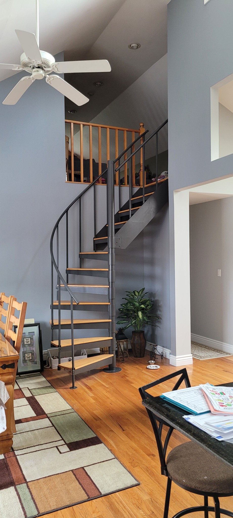 Interior walls, ceilings, and open staircase railing with painted metal and natural wood.
