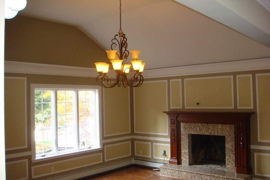 Repainted walls, white crown molding, and wainscoting in an interior room.